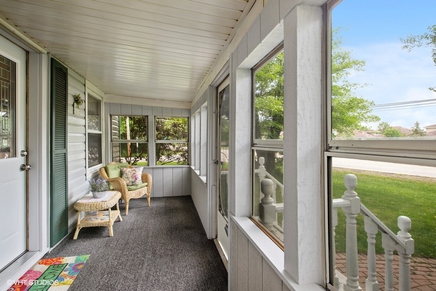 8808 Bard Road Crystal Lake, IL 60014 - Photo 4 of 32 a balcony with chairs and couch