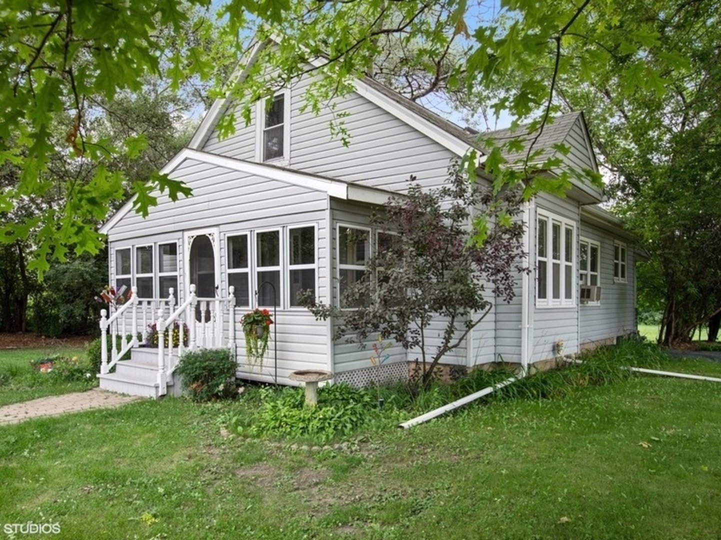 8808 Bard Road Crystal Lake, IL 60014 - Photo 32 of 32 a front view of house with a garden and patio