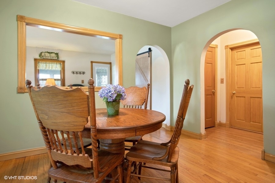 8808 Bard Road Crystal Lake, IL 60014 - Photo 8 of 32 a dining room with furniture and wooden floor