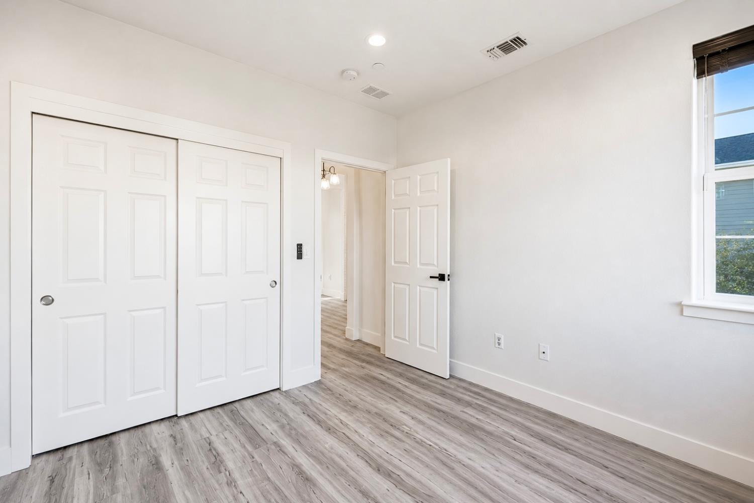 1837 South La Barbera Avenue Mountain House, CA 95391 - Photo 9 of 54 a view of an empty room with wooden floor