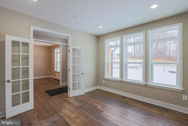 a kitchen with stainless steel appliances granite countertop a sink a stove and a wooden floors