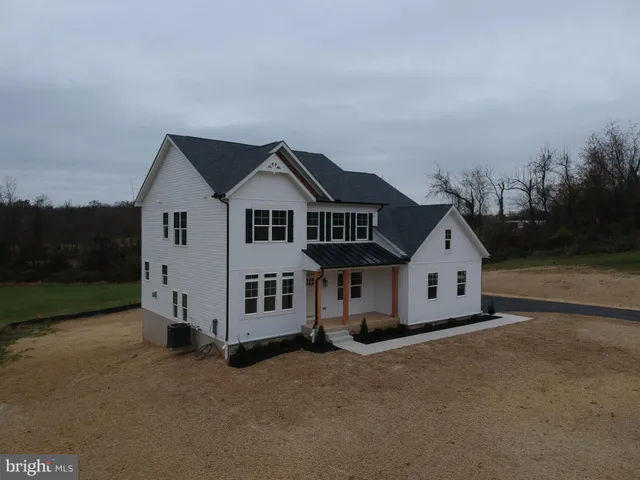 an aerial view of a house with yard