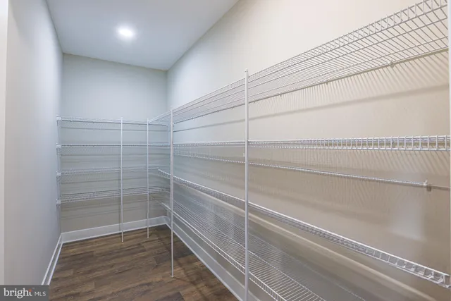 a bathroom with a bathtub shower sink mirror and toilet