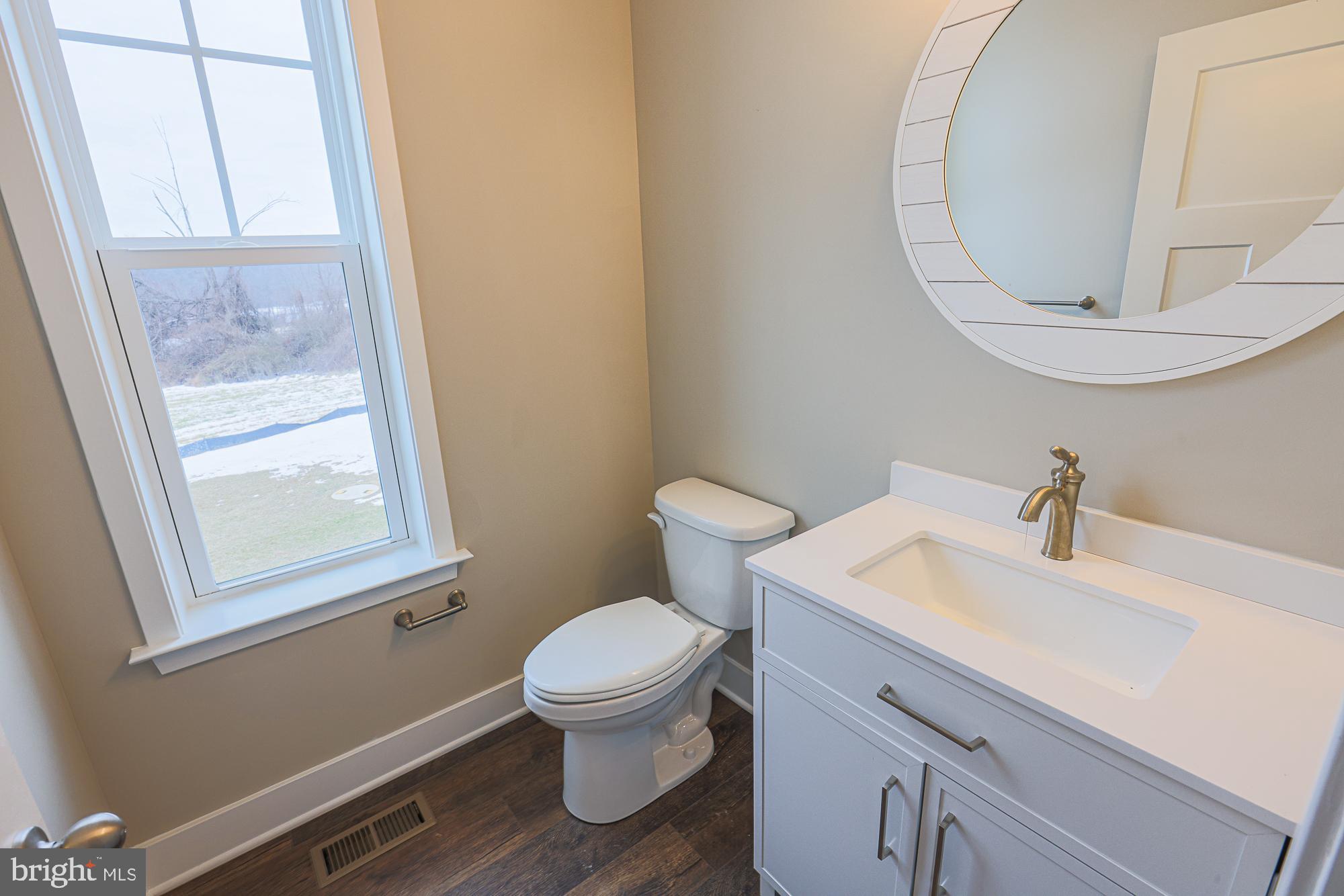 4712 Carroll Manor Road Baldwin, MD 21013 - Photo 31 of 69 a bathroom with a sink a toilet and a mirror