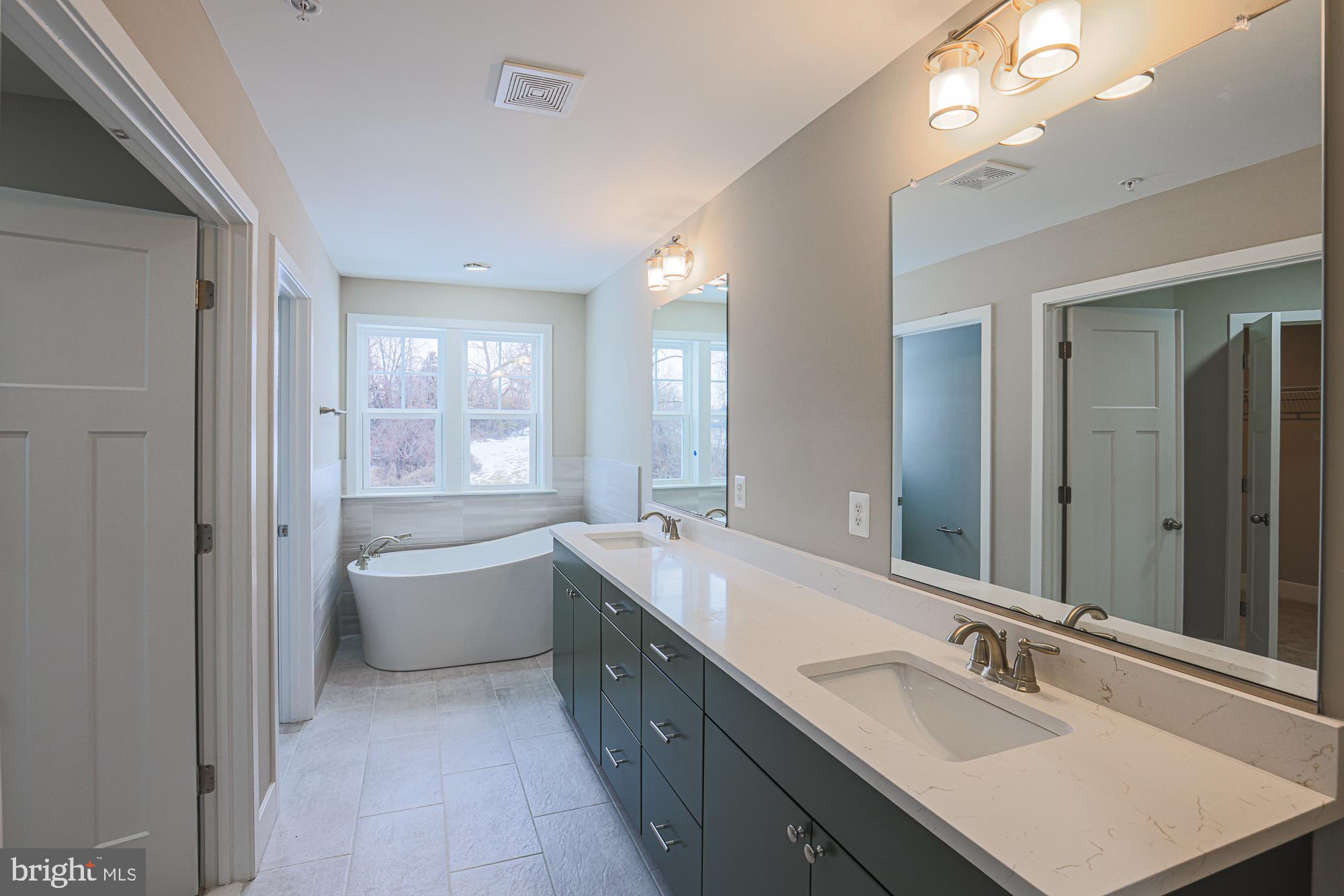 4712 Carroll Manor Road Baldwin, MD 21013 - Photo 52 of 69 a bathroom with a tub double vanity sink and mirror