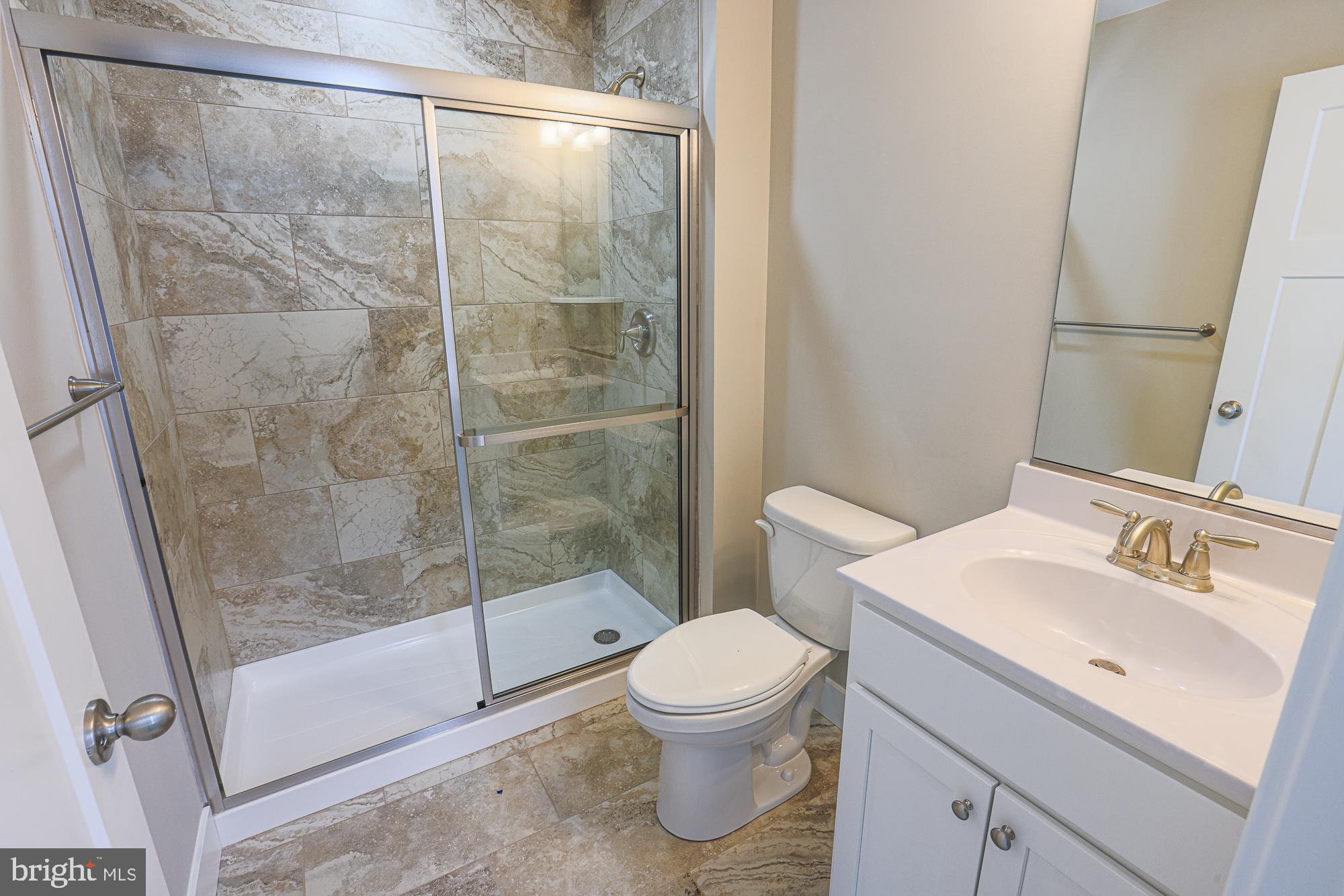 4712 Carroll Manor Road Baldwin, MD 21013 - Photo 60 of 69 a bathroom with a shower a toilet and a sink