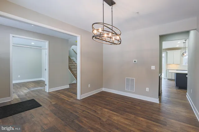 a large kitchen with a lot of counter space and wooden floor