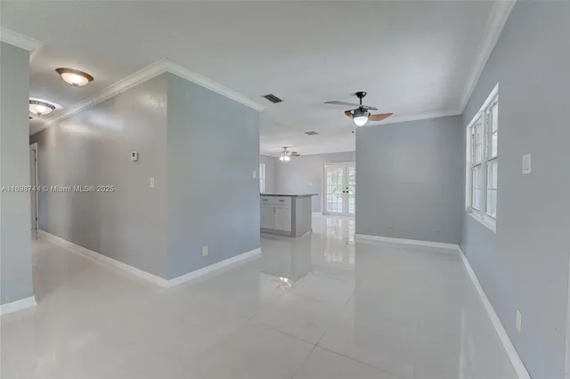 wooden floor in an empty room with a bathroom
