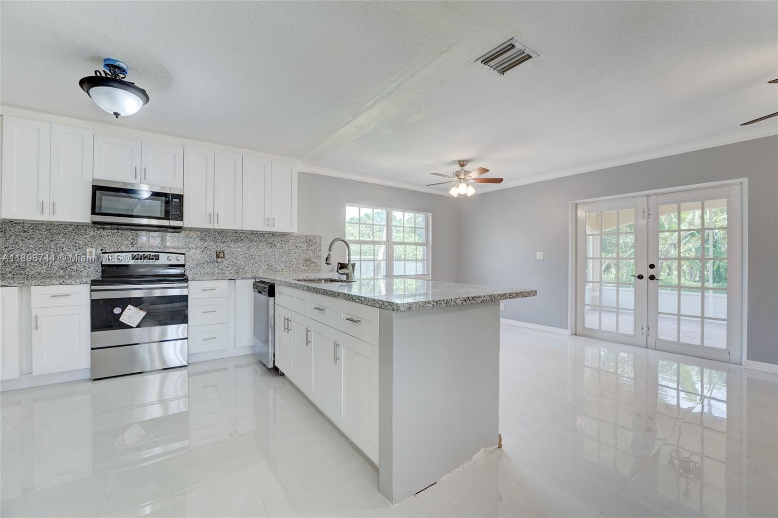 5130 Southwest 208th Lane Southwest Ranches, FL 33332 - Photo 16 of 53 a kitchen with stainless steel appliances a sink stove and cabinets