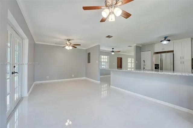 a view of a livingroom with a ceiling fan and window