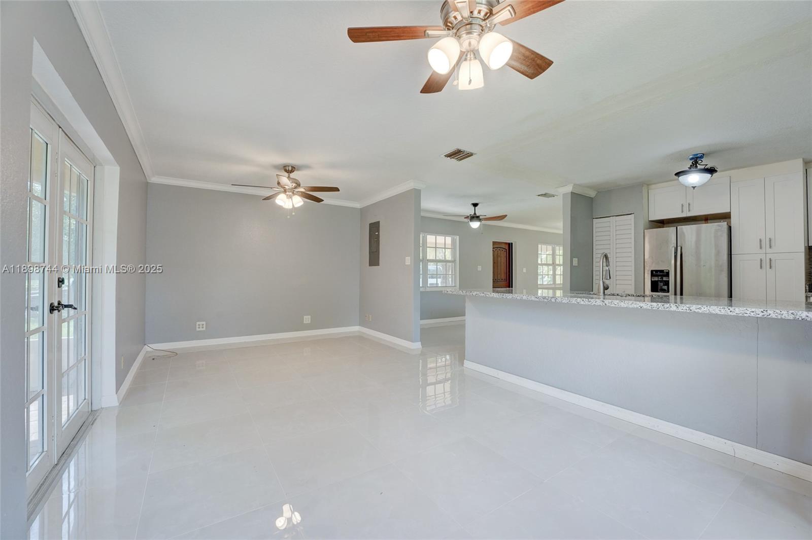 5130 Southwest 208th Lane Southwest Ranches, FL 33332 - Photo 20 of 53 a view of a livingroom with a ceiling fan and window