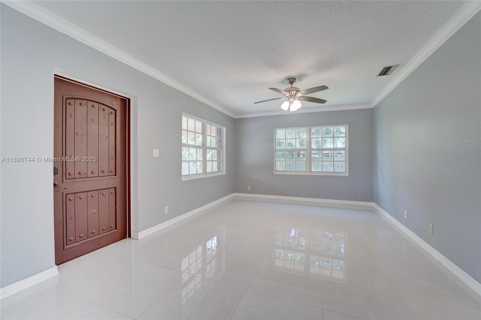 5130 Southwest 208th Lane Southwest Ranches, FL 33332 - Photo 25 of 53 an empty room with windows and ceiling fan