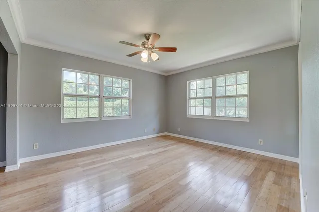 wooden floor in an empty room with a window