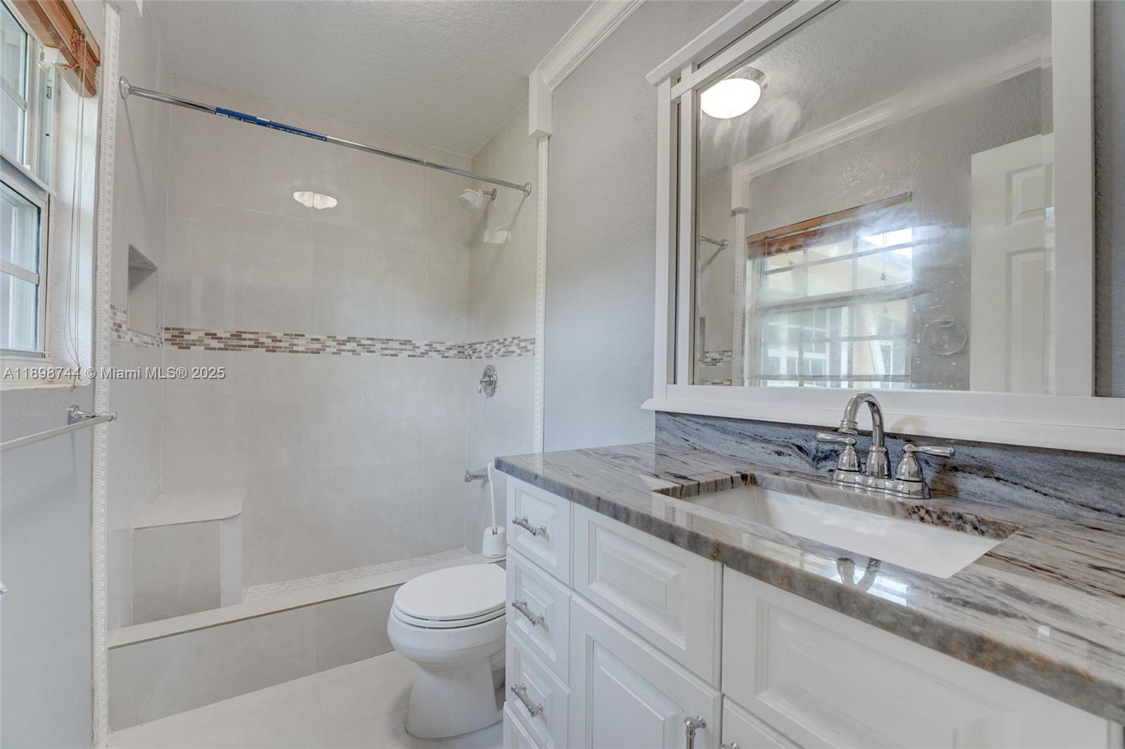 5130 Southwest 208th Lane Southwest Ranches, FL 33332 - Photo 29 of 53 a bathroom with a granite countertop sink toilet and shower