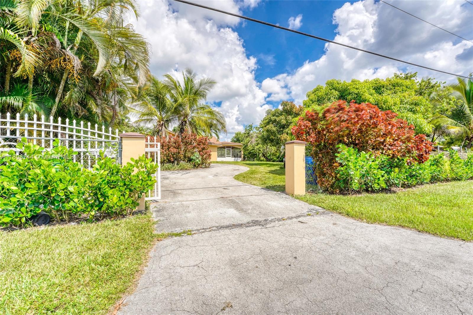 5130 Southwest 208th Lane Southwest Ranches, FL 33332 - Photo 3 of 53 a front view of a house with a yard and a garden