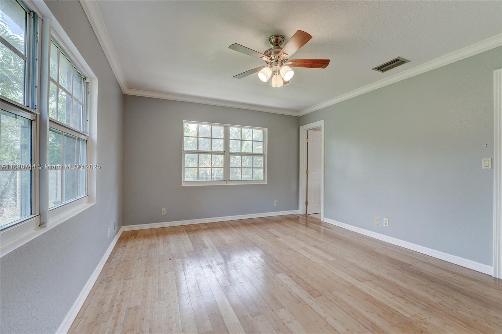 5130 Southwest 208th Lane Southwest Ranches, FL 33332 - Photo 31 of 53 a view of an empty room with a window and wooden floor