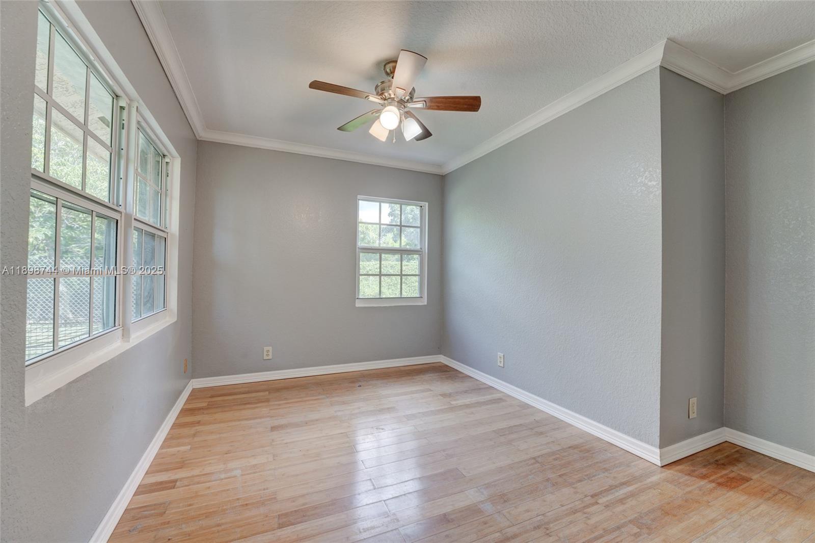 5130 Southwest 208th Lane Southwest Ranches, FL 33332 - Photo 32 of 53 a view of an empty room with wooden floor and a window