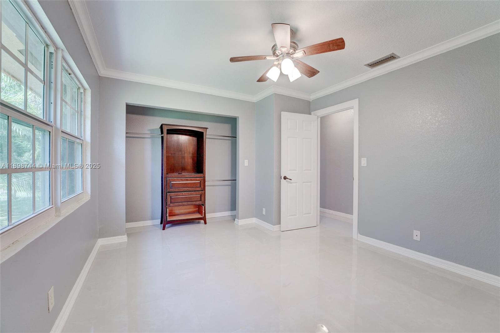 5130 Southwest 208th Lane Southwest Ranches, FL 33332 - Photo 38 of 53 a view of an empty room with a chandelier fan and windows