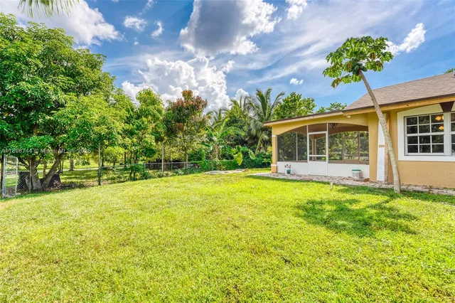 a view of a house with a backyard