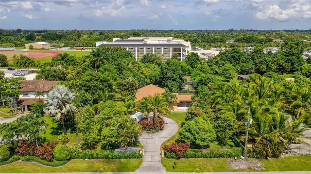 an aerial view of a house with a yard and lake view