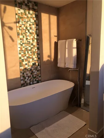 a bath tub sitting in a bathroom next to a window