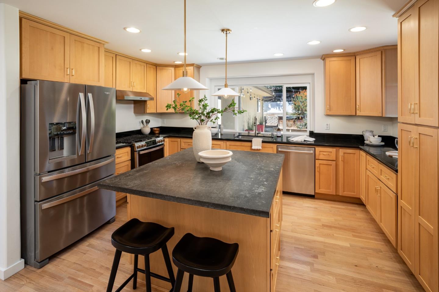 6932 Freedom Boulevard Aptos, CA 95003 - Photo 13 of 49 a kitchen with stainless steel appliances granite countertop a sink refrigerator stove and a microwave oven with wooden floor