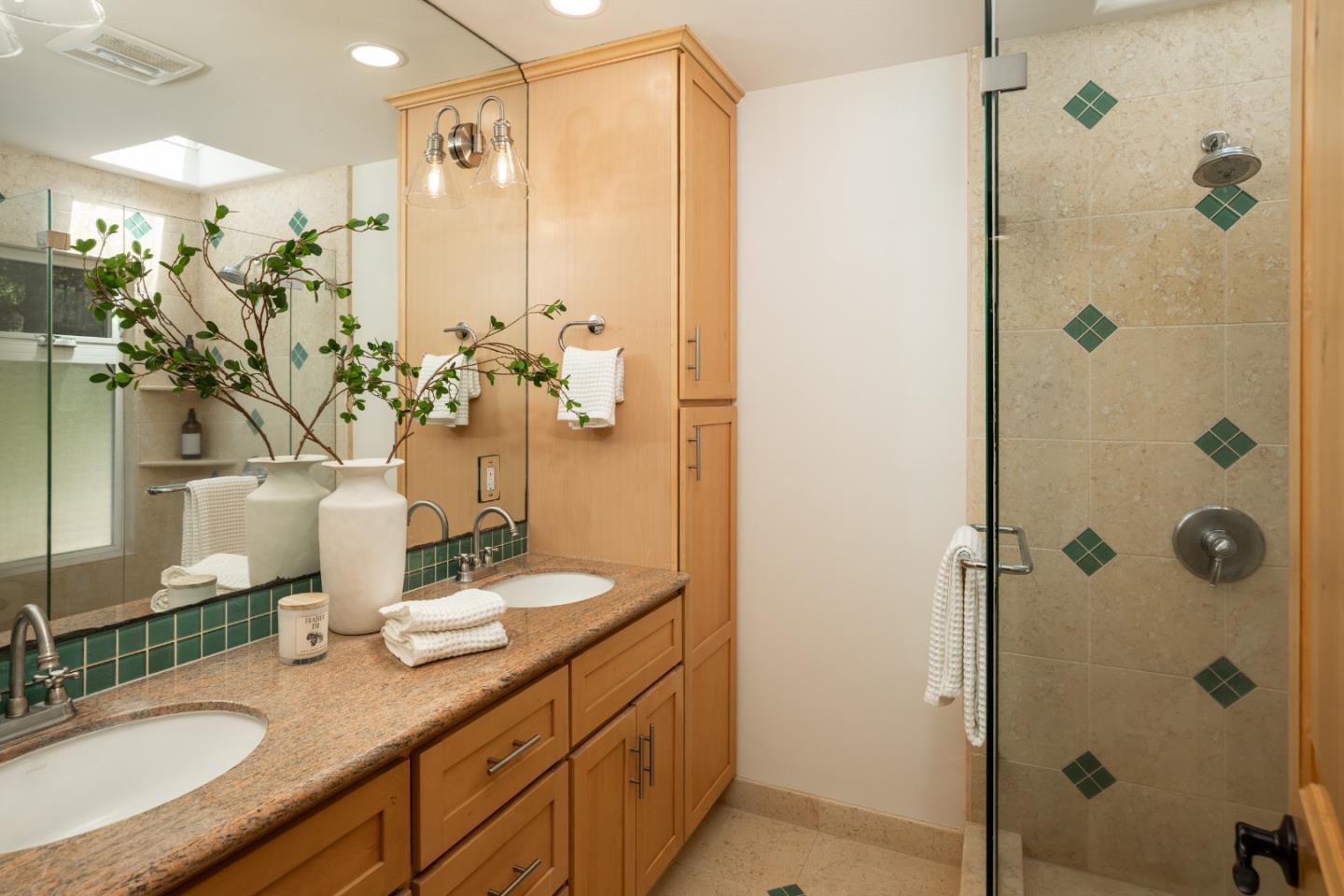 6932 Freedom Boulevard Aptos, CA 95003 - Photo 15 of 49 a bathroom with a double vanity sink mirror and shower