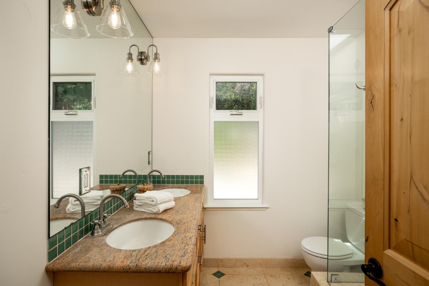 6932 Freedom Boulevard Aptos, CA 95003 - Photo 18 of 49 a bathroom with a sink double vanity and a toilet