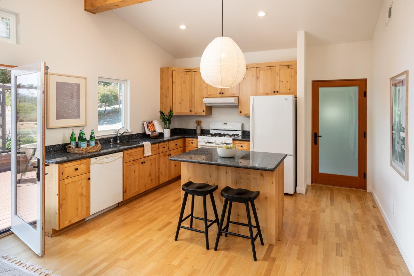 6932 Freedom Boulevard Aptos, CA 95003 - Photo 23 of 49 a kitchen with stainless steel appliances granite countertop wooden floors and white cabinets