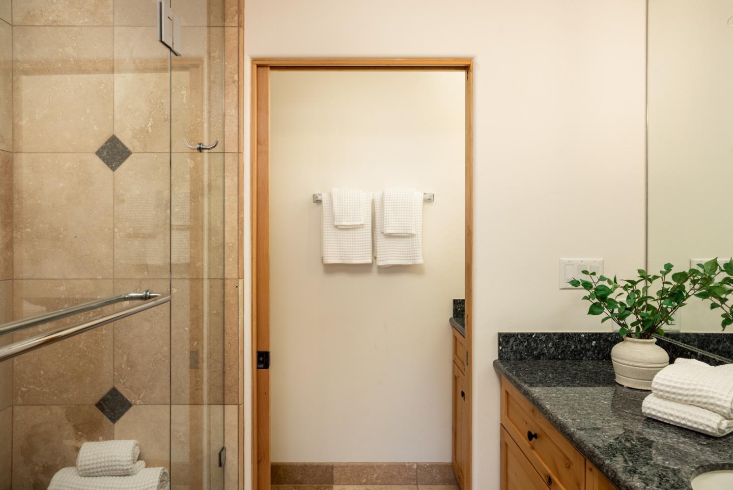 6932 Freedom Boulevard Aptos, CA 95003 - Photo 26 of 49 a bathroom with a granite countertop sink a mirror and a shower