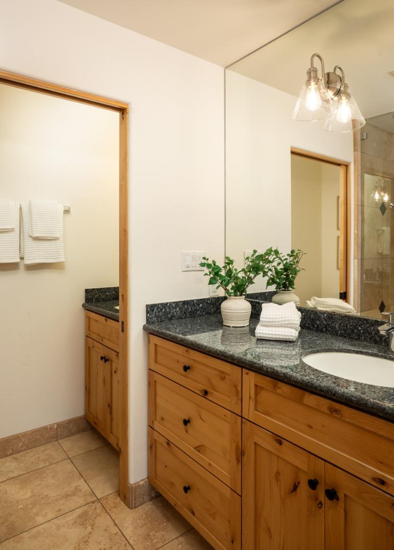 6932 Freedom Boulevard Aptos, CA 95003 - Photo 27 of 49 a bathroom with a granite countertop sink and a mirror