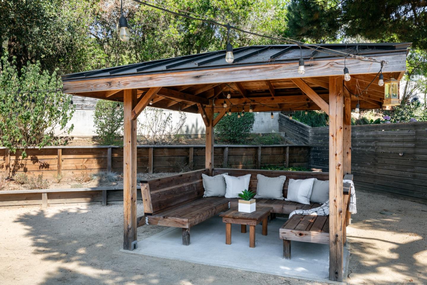 6932 Freedom Boulevard Aptos, CA 95003 - Photo 39 of 49 a view of patio with a table and chairs under an umbrella with a small yard