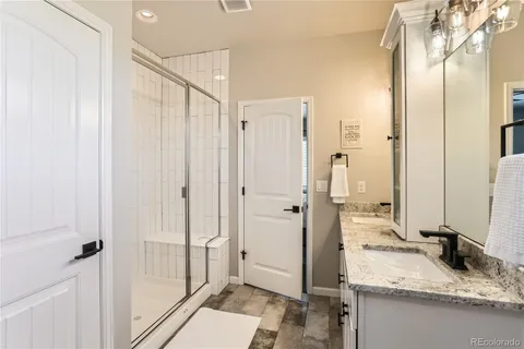 a bathroom with a sink double vanity and a mirror