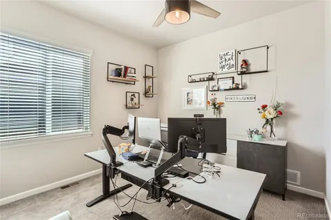 a bathroom with a granite countertop sink mirror vanity and toilet