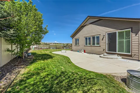 a backyard of a house with yard and outdoor seating