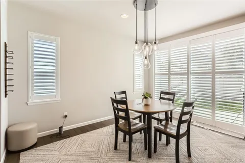 a kitchen with kitchen island a white cabinets and refrigerator