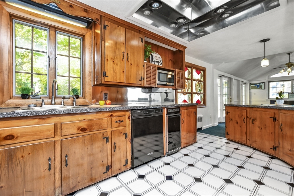 25 Anna Road Woburn, MA 01801 - Photo 14 of 39 a kitchen with stainless steel appliances kitchen island granite countertop a refrigerator and a stove top oven
