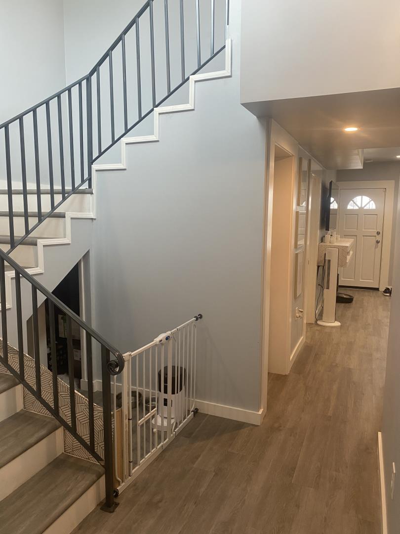 1132 85th Avenue Oakland, CA 94621 - Photo 18 of 28 a view of staircase with railing and a chandelier