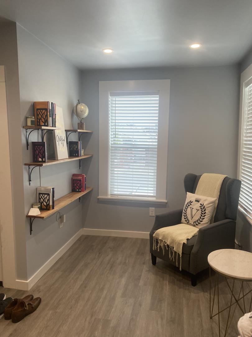 1132 85th Avenue Oakland, CA 94621 - Photo 9 of 28 a bedroom with furniture and a wooden floor