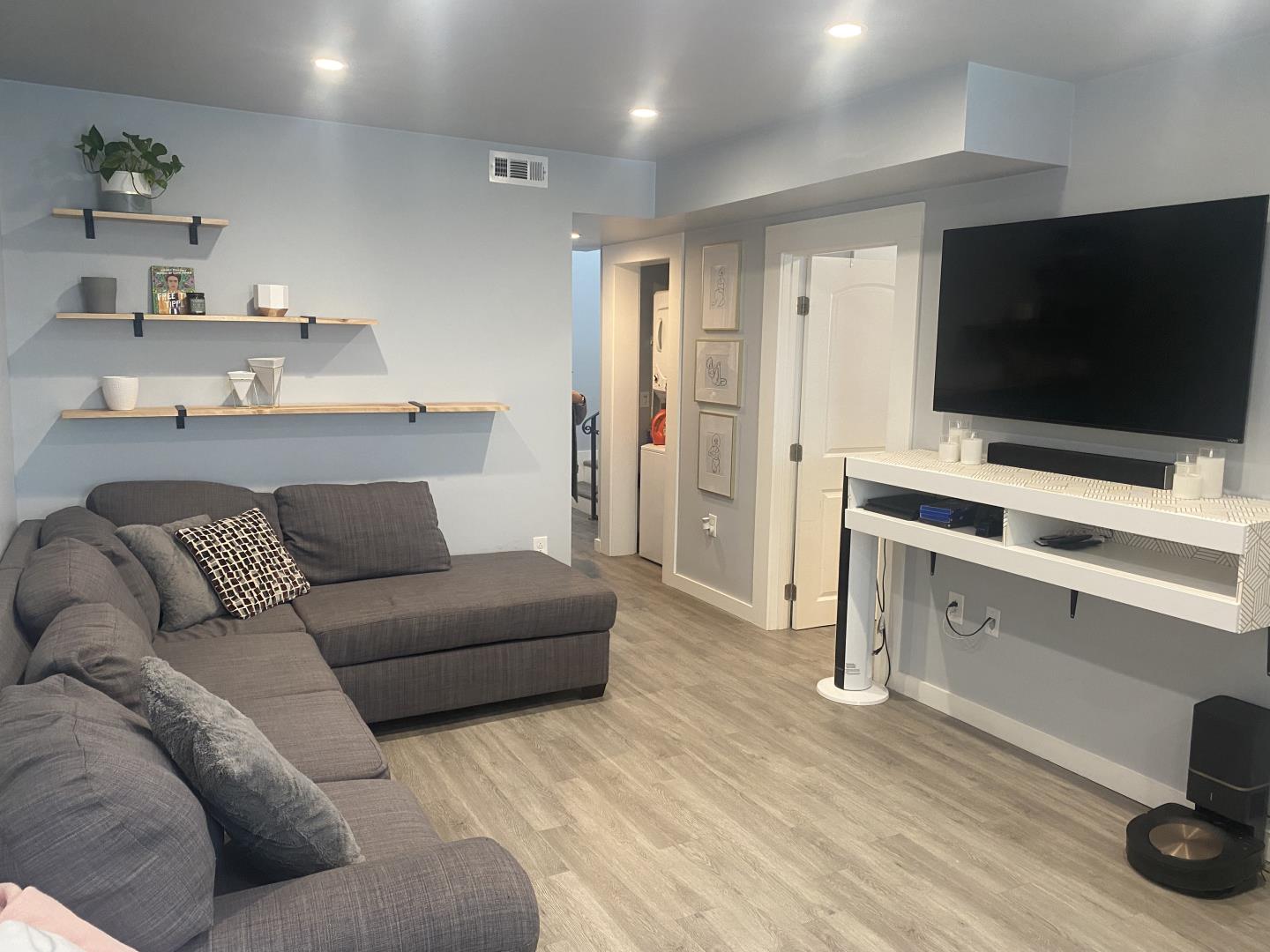 1132 85th Avenue Oakland, CA 94621 - Photo 10 of 28 a living room with furniture and a flat screen tv