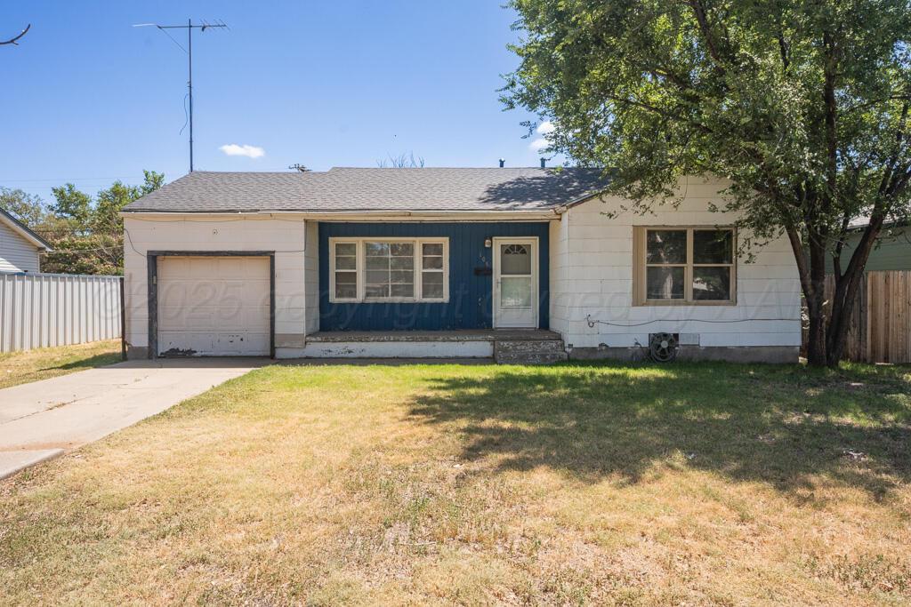 108 Spruce Avenue Dumas, TX 79029 - Photo 1 of 15 a front view of a house with garden
