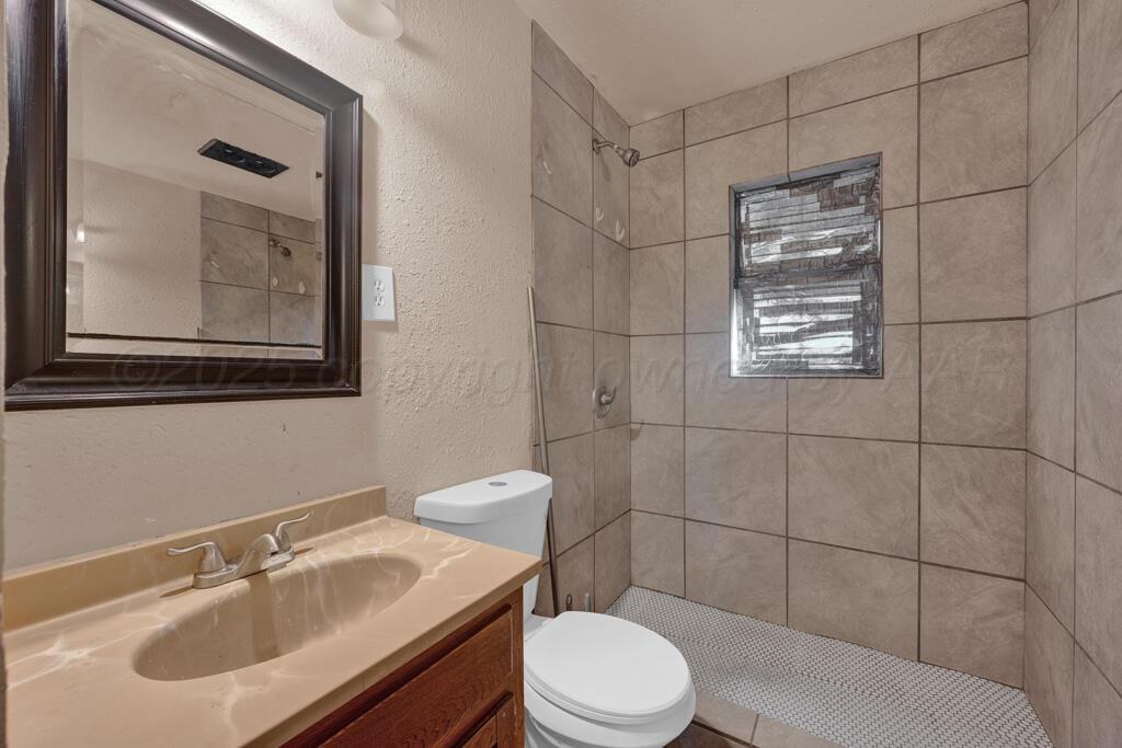 108 Spruce Avenue Dumas, TX 79029 - Photo 13 of 15 a bathroom with a sink toilet and shower
