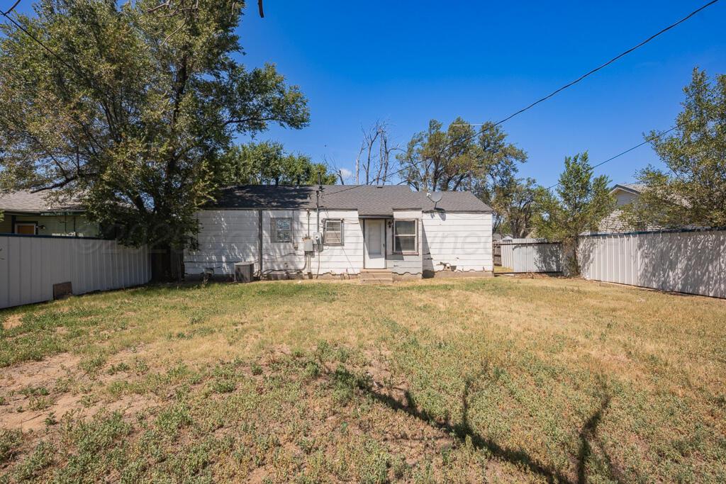 108 Spruce Avenue Dumas, TX 79029 - Photo 14 of 15 a house with trees in front of it