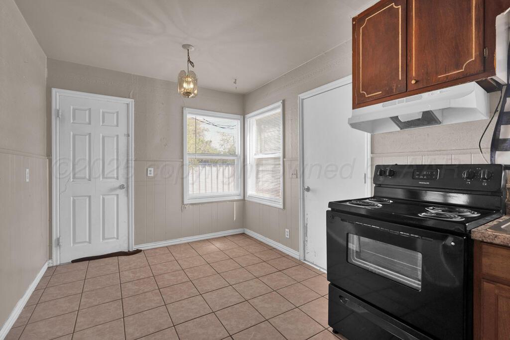 108 Spruce Avenue Dumas, TX 79029 - Photo 8 of 15 a kitchen with a stove and a microwave