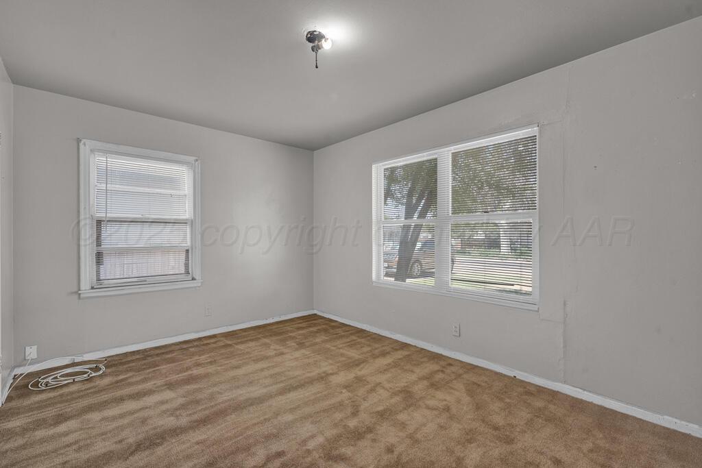 108 Spruce Avenue Dumas, TX 79029 - Photo 10 of 15 an empty room with windows