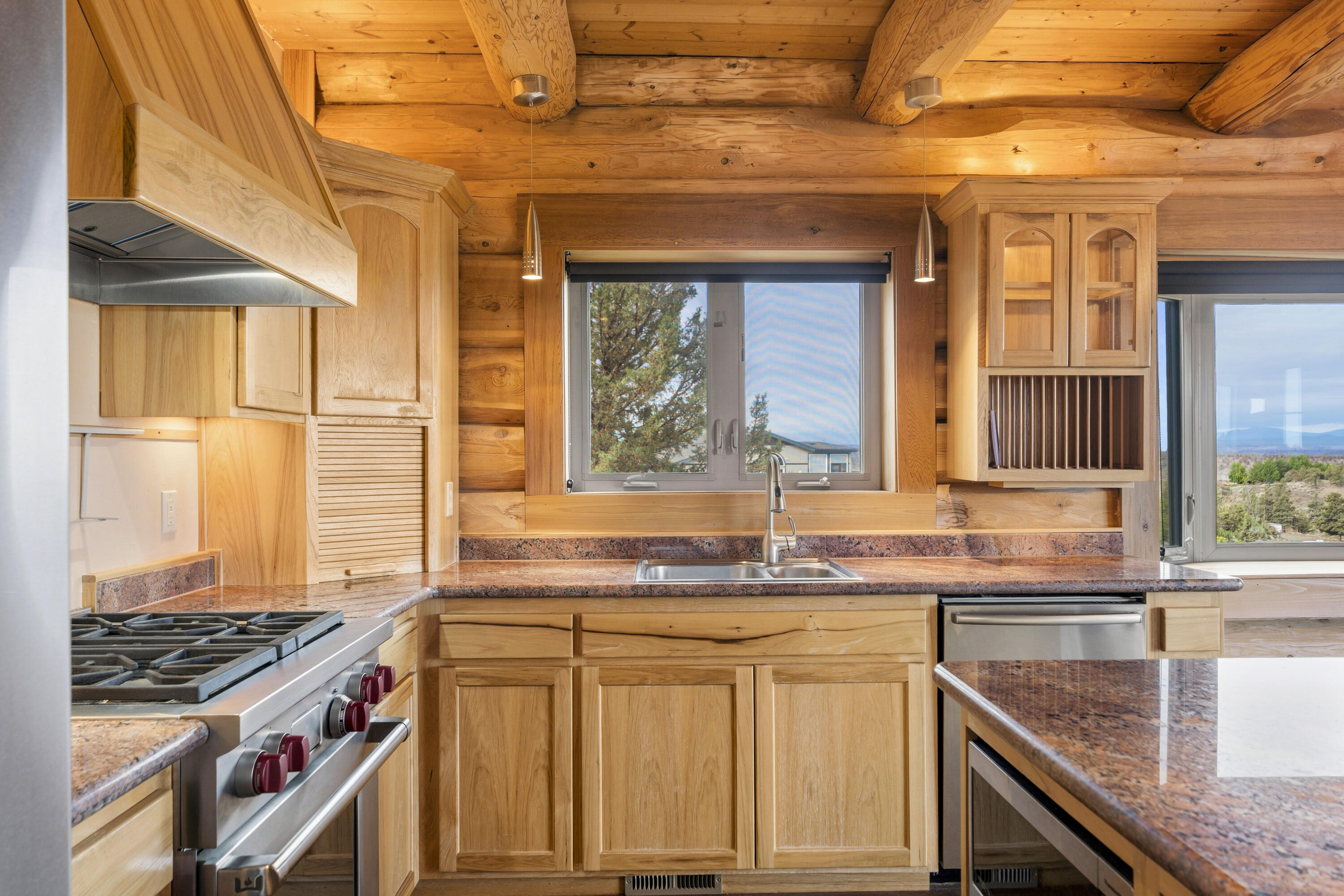 10739 Southwest Shad Road Terrebonne, OR 97760 - Photo 36 of 55 a kitchen with granite countertop a sink and a stove