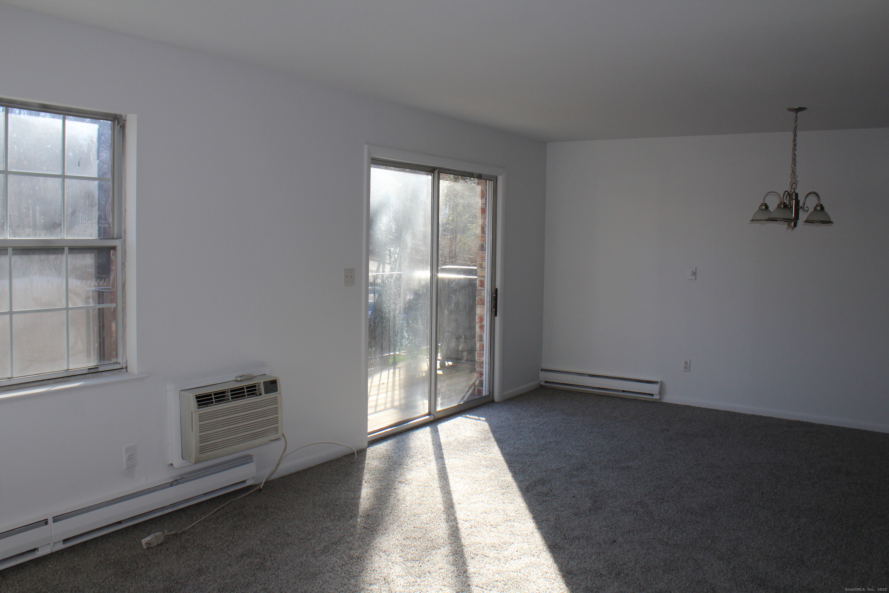 39 Woodway Road, Unit C7 Stamford, CT 06907 - Photo 4 of 18 an empty room with windows