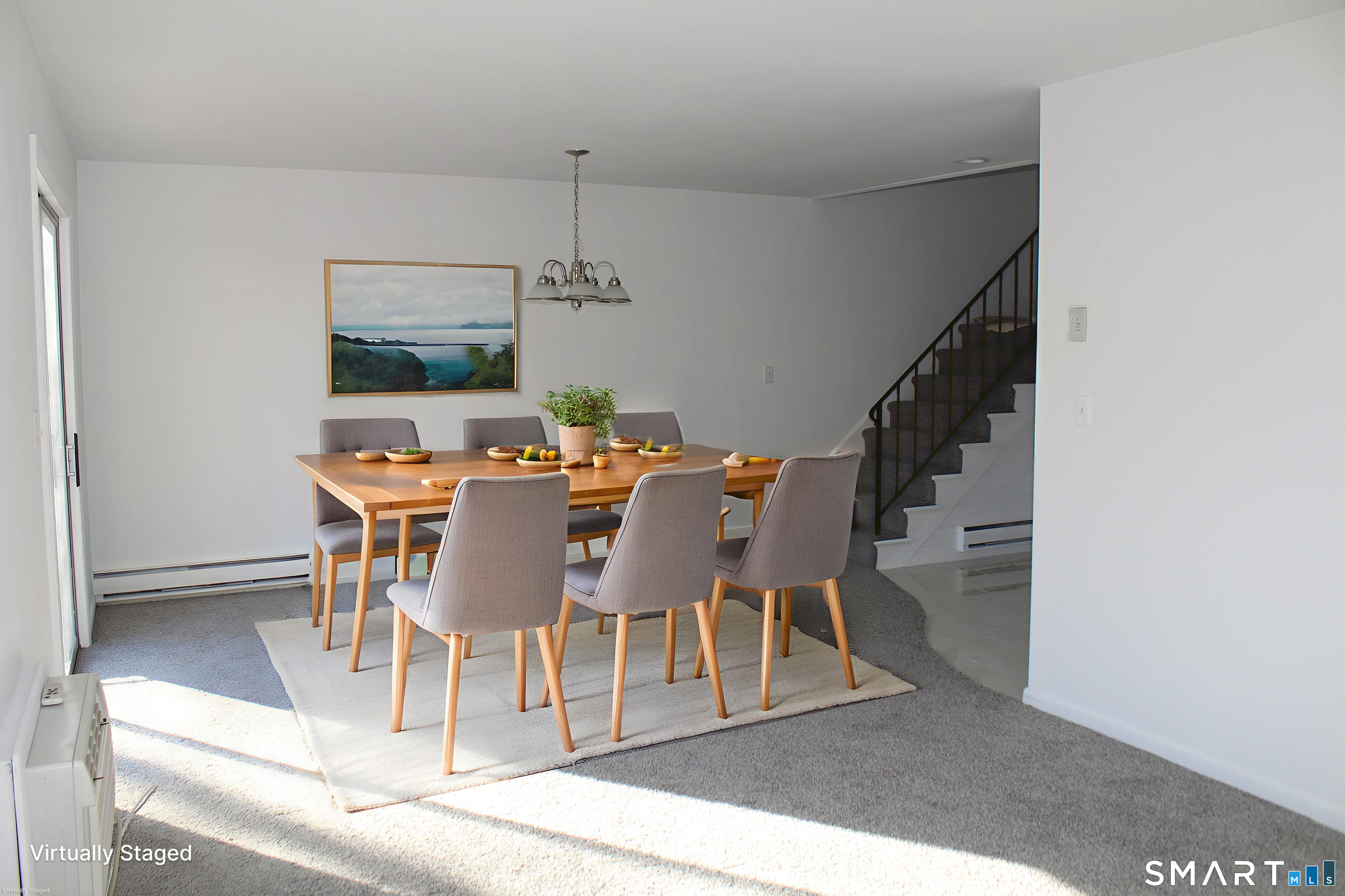 39 Woodway Road, Unit C7 Stamford, CT 06907 - Photo 5 of 18 a dining room with furniture a chandelier and wooden floor