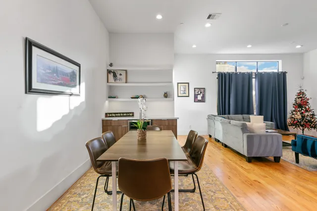 a large kitchen with kitchen island a island a stove a sink a center island and a wooden floor