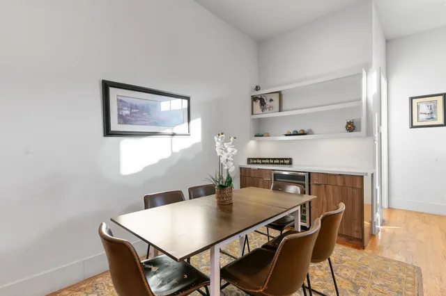 a view of a dining room with furniture and wooden floor